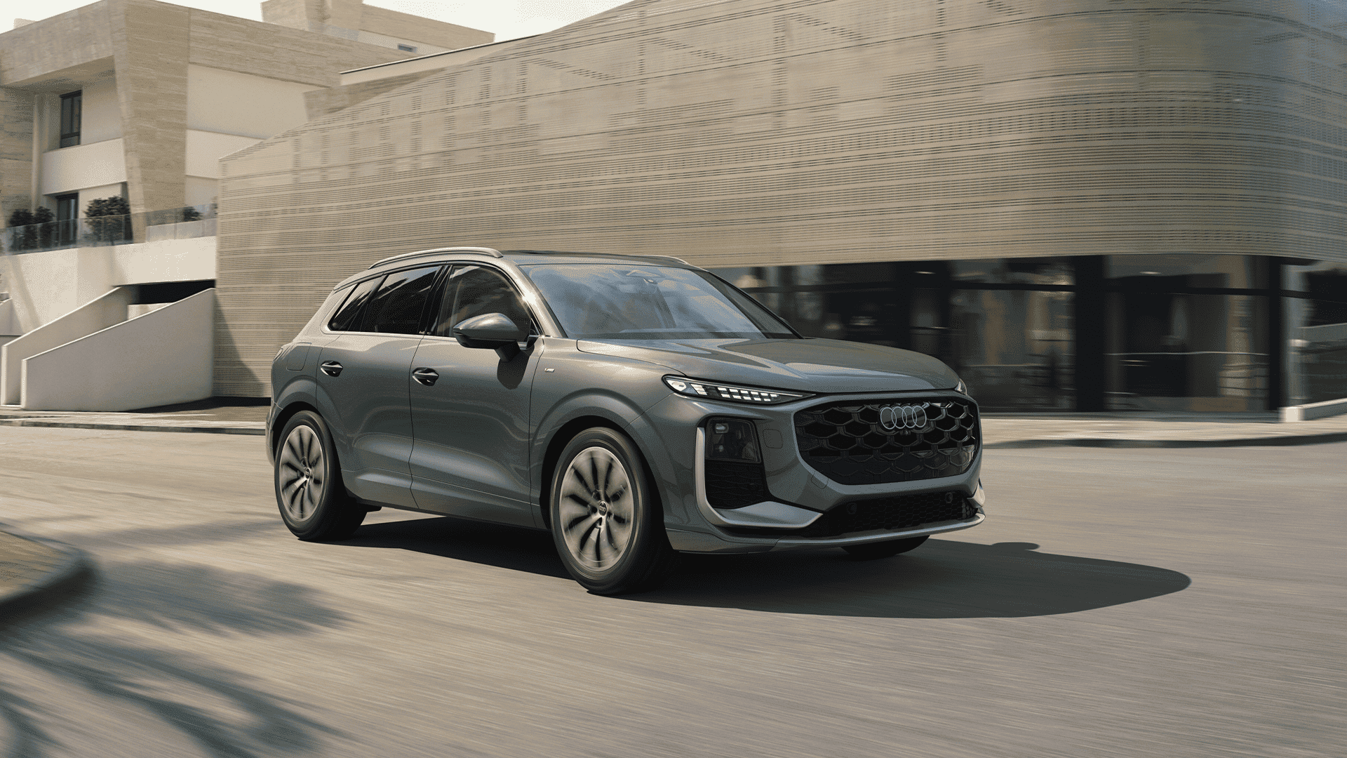 Left side profile view of an Audi Q3 accelerating.